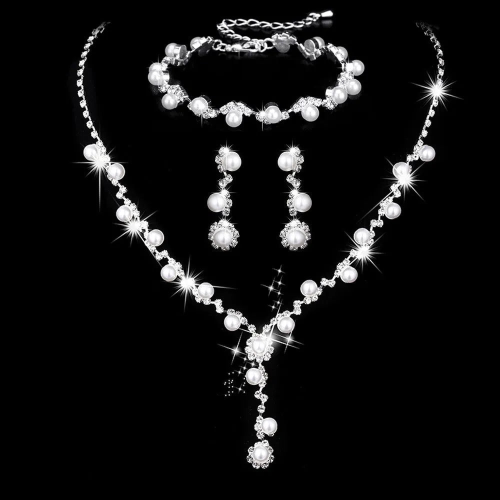 Pearl three-piece fashion jewellery set with crystal rhinestone accents, bamboo chain necklace, earrings, and bracelet on display