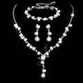 Pearl three-piece fashion jewellery set with crystal rhinestone accents, bamboo chain necklace, earrings, and bracelet on display