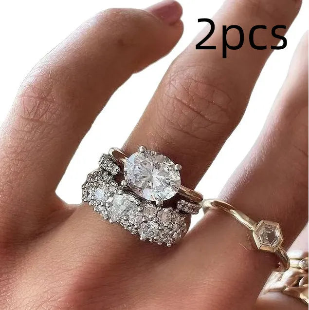 Women's three-piece ring set with mosaic oval zircon stones in white alloy finish on a dark surface