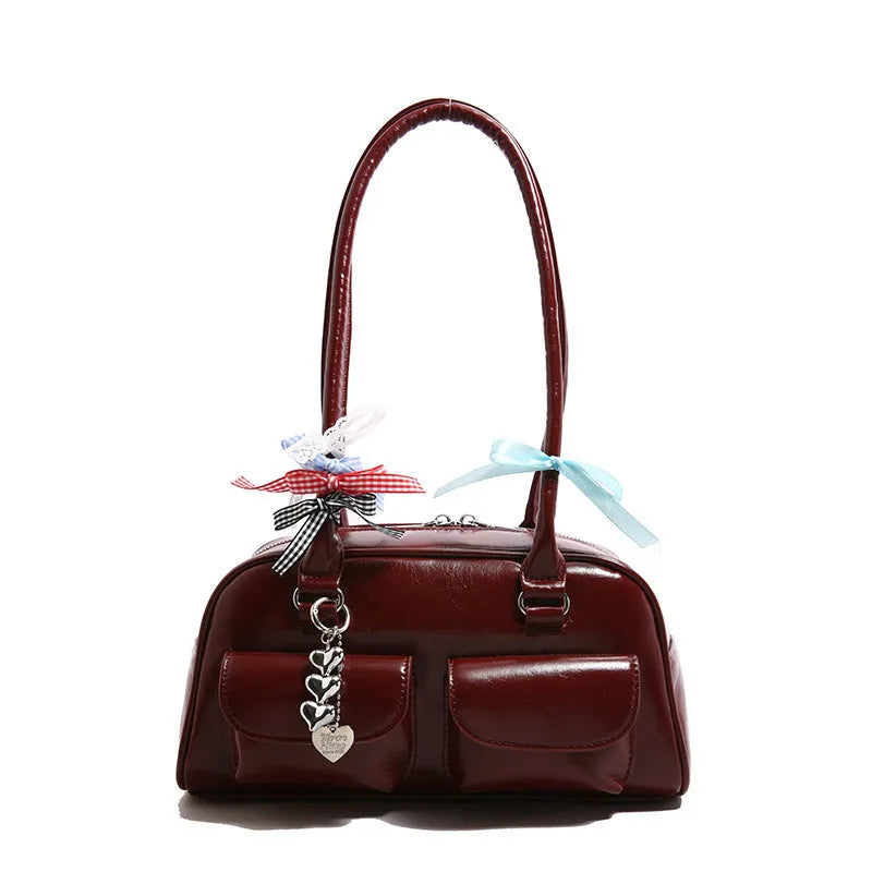 Retro brown PU leather pillow-shaped women's handbag with double straps and a flap closure.