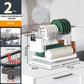 White double-layer kitchen storage and draining rack made from carbon steel on a countertop.