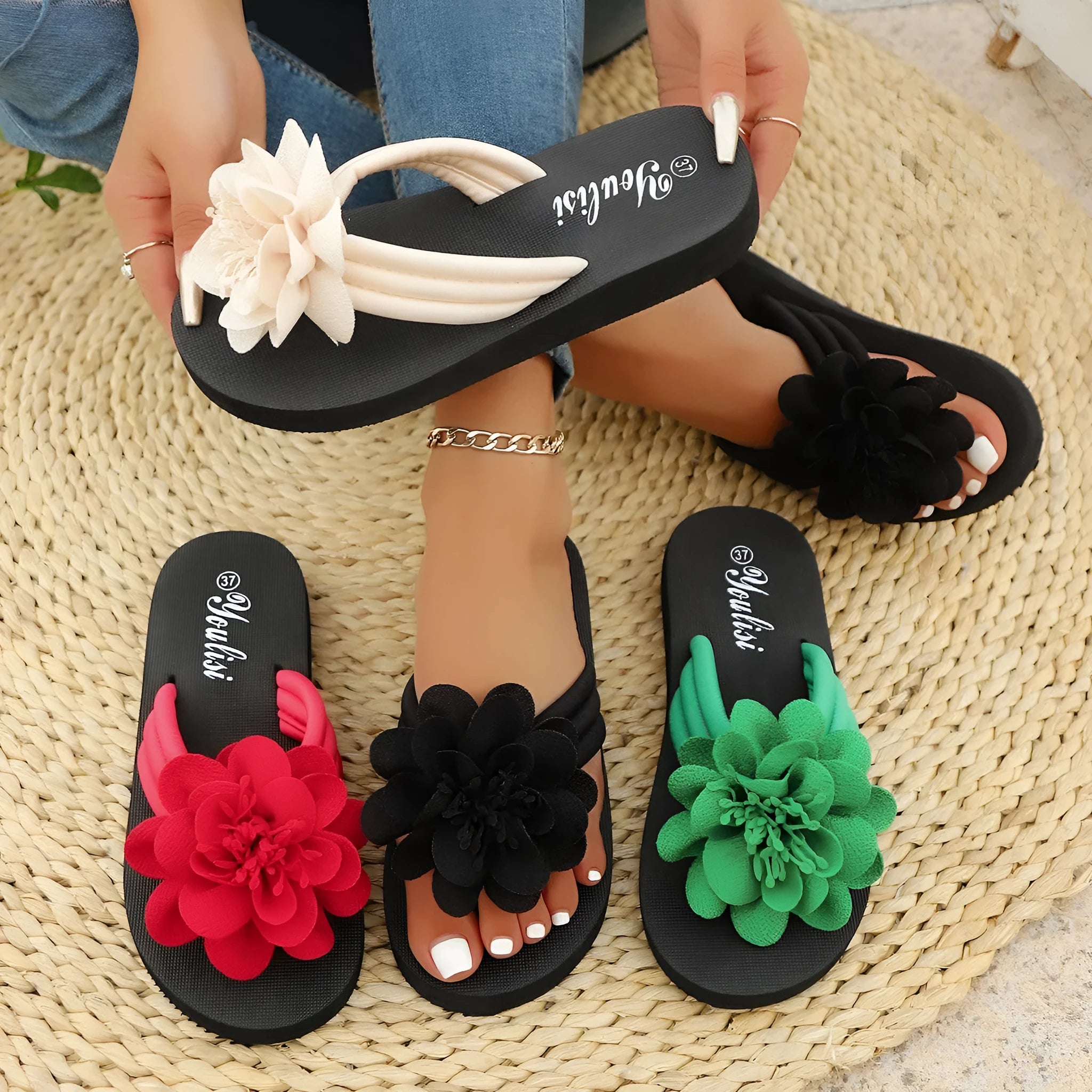 A pair of casual beige flip-flops with a floral decoration on the strap and a lightweight EVA sole.
