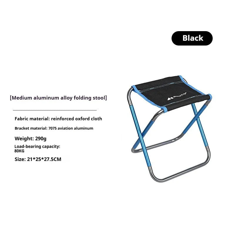 Black ethnic style aluminium alloy folding camping stool shown in use outdoors.