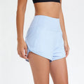 Women's high-waist nylon sports shorts in water blue, shown for summer fitness and running.