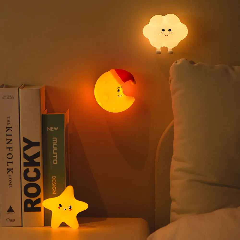 Moon XINGX Cloud silicone lamp with warm light, magnetic suction base, and cartoon design on a bedside table