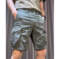 Man wearing loose straight-leg khaki overalls with multiple pockets, showcasing the Korean-style relaxed fit.