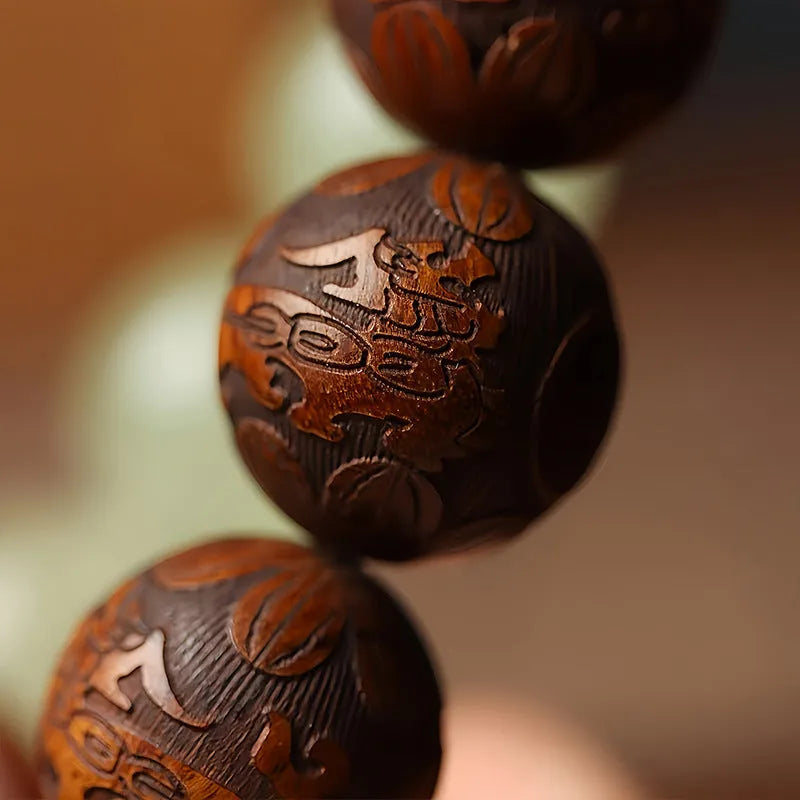 Rosewood bracelet with carved Fu character and amass fortunes design showing 12 wooden beads