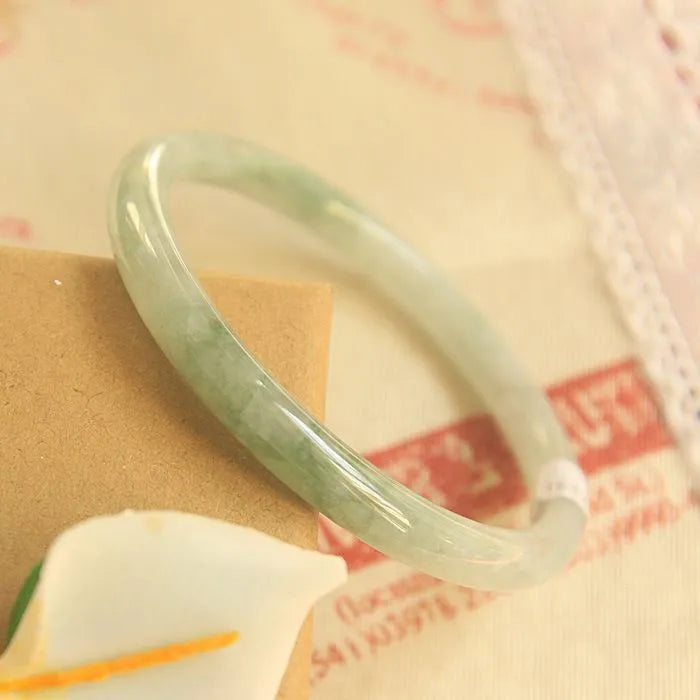 Traditional green jade waxy Chinese bracelet with geometric design showing 10mm profile