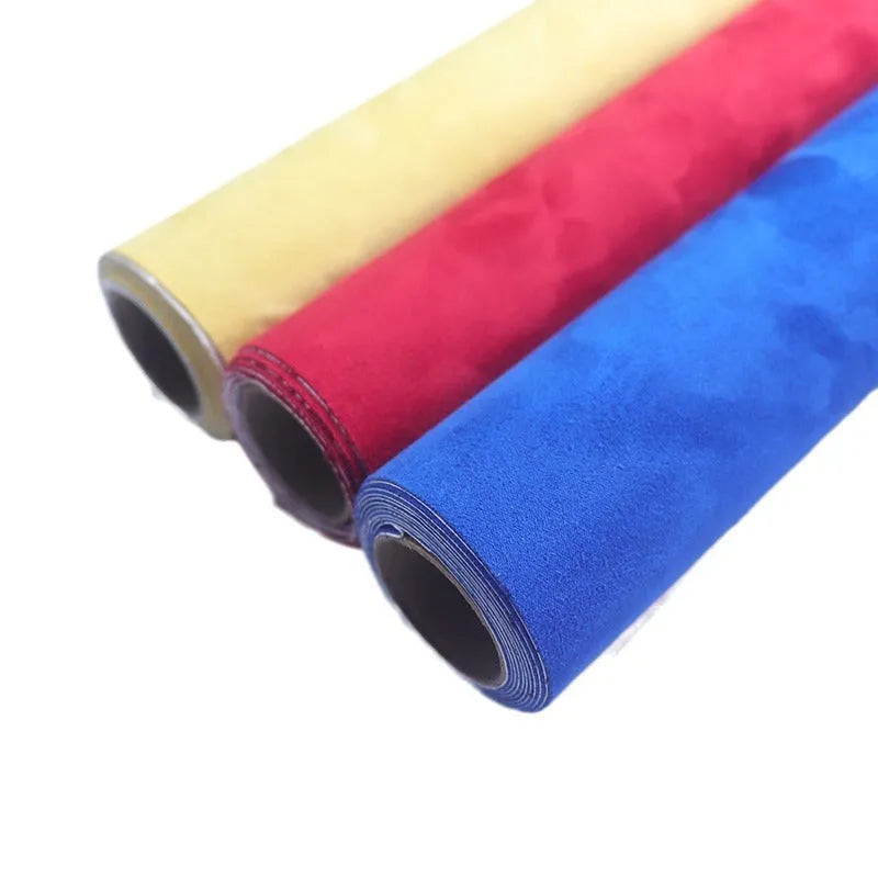 Sheet of self-adhesive leather suede fabric showing texture, available in multiple colours like black, brown, blue, and red.