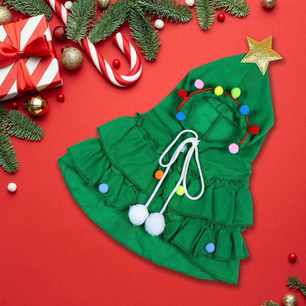 Cat wearing Christmas tree costume with star ornament in green