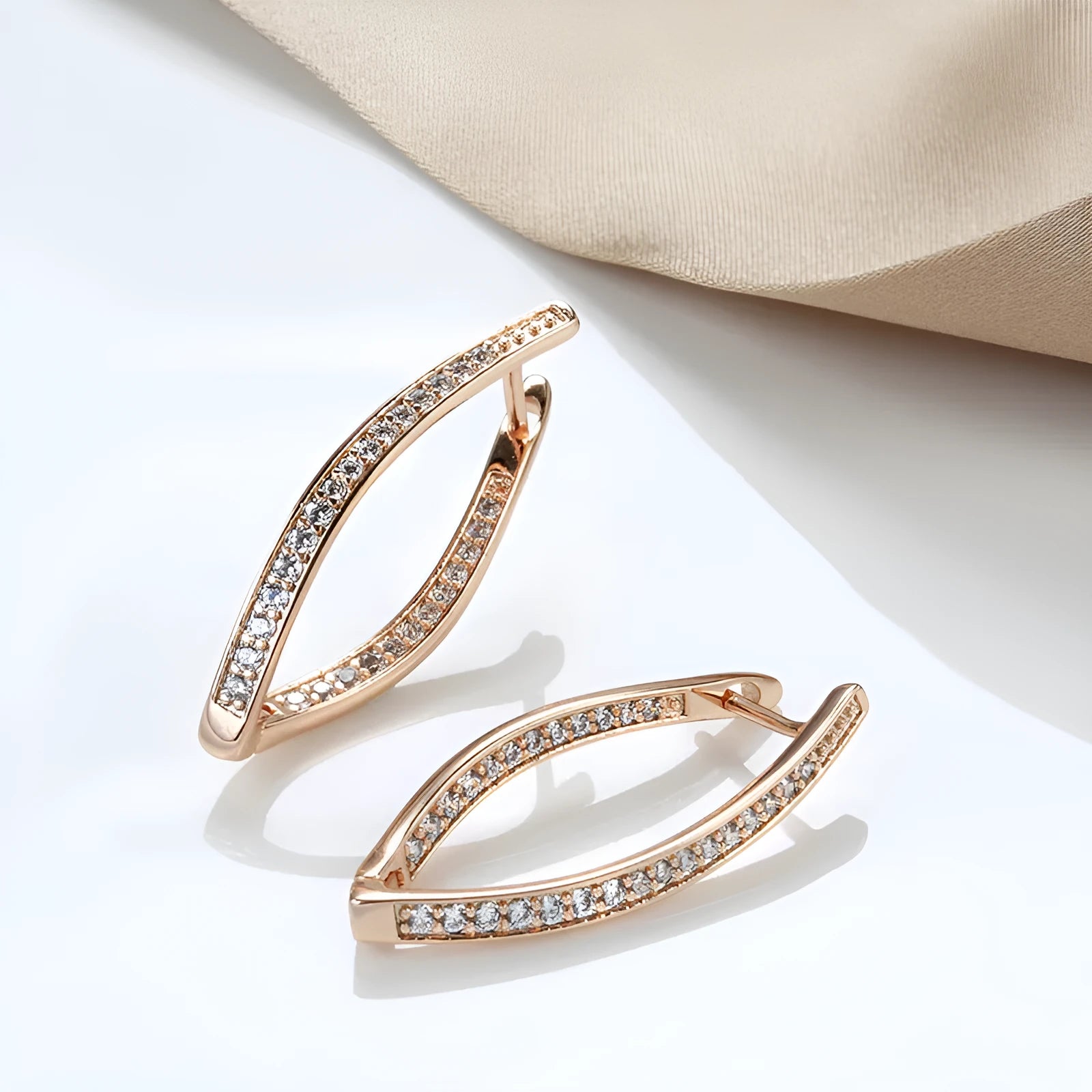 Pair of H0493 copper geometric drop earrings with zircon accents for women on light background