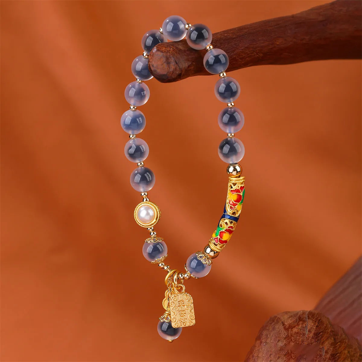 Close-up of a women's sugar heart agate beaded bracelet with an adjustable knot closure on a wrist