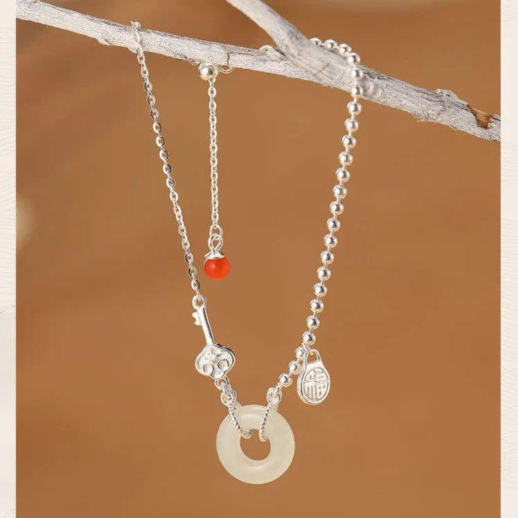 Women's silver bracelet with Hetian jade and geometric peace buckle design in Chinese style