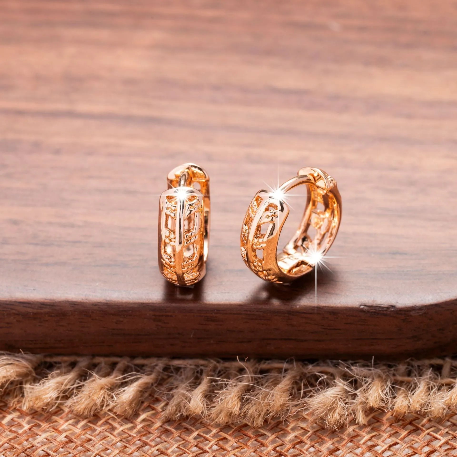 Rose gold coloured copper earrings with hollowed-out heart and leaf designs.