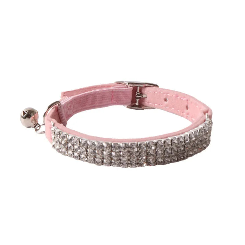 Soft flocked cat collar with elastic buckle in multiple colours on a white background.