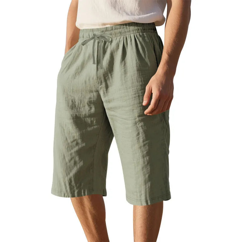 Men's solid colour linen shorts with a drawstring waist shown in a light blue shade.