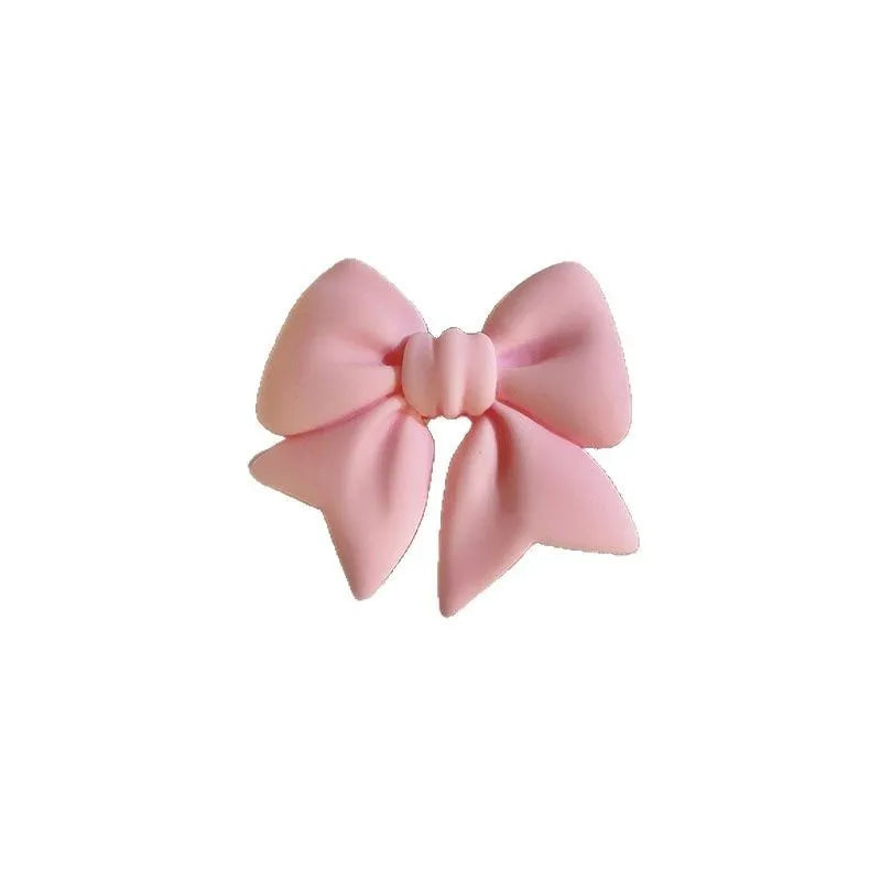 Bow bracket plastic mobile phone stand for lazy binge-watching, available in pink, purple, rose red, yellow, and blue.