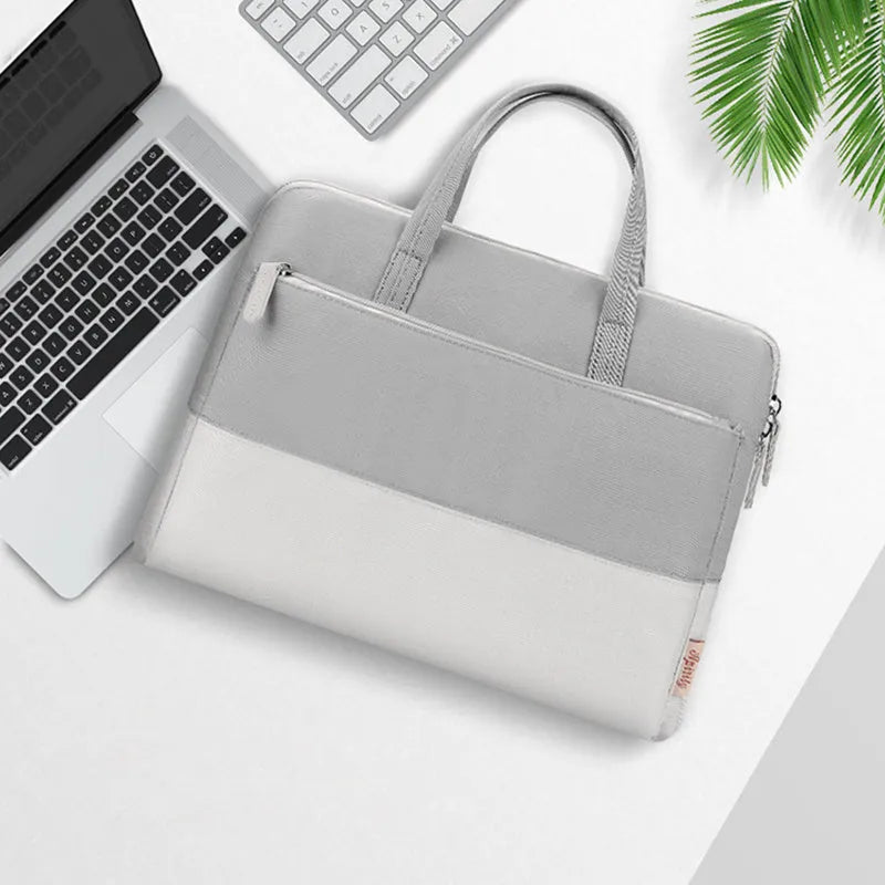 Pink laptop single-shoulder bag made of Oxford cloth with anti-theft design and breathable back panel, shown with soft carry handle