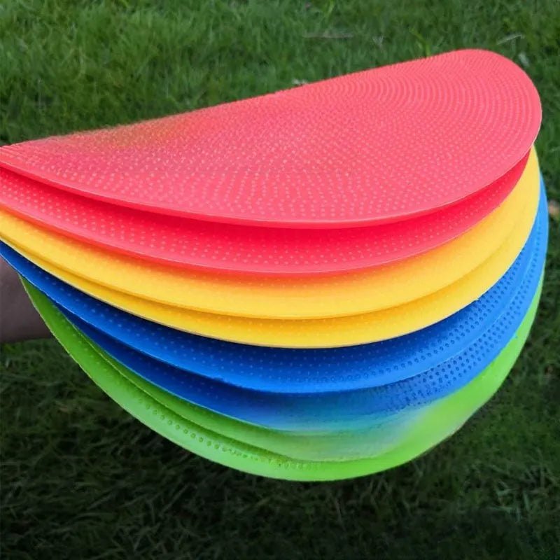 Circular yellow football training marker disc on grass field showing 23cm diameter