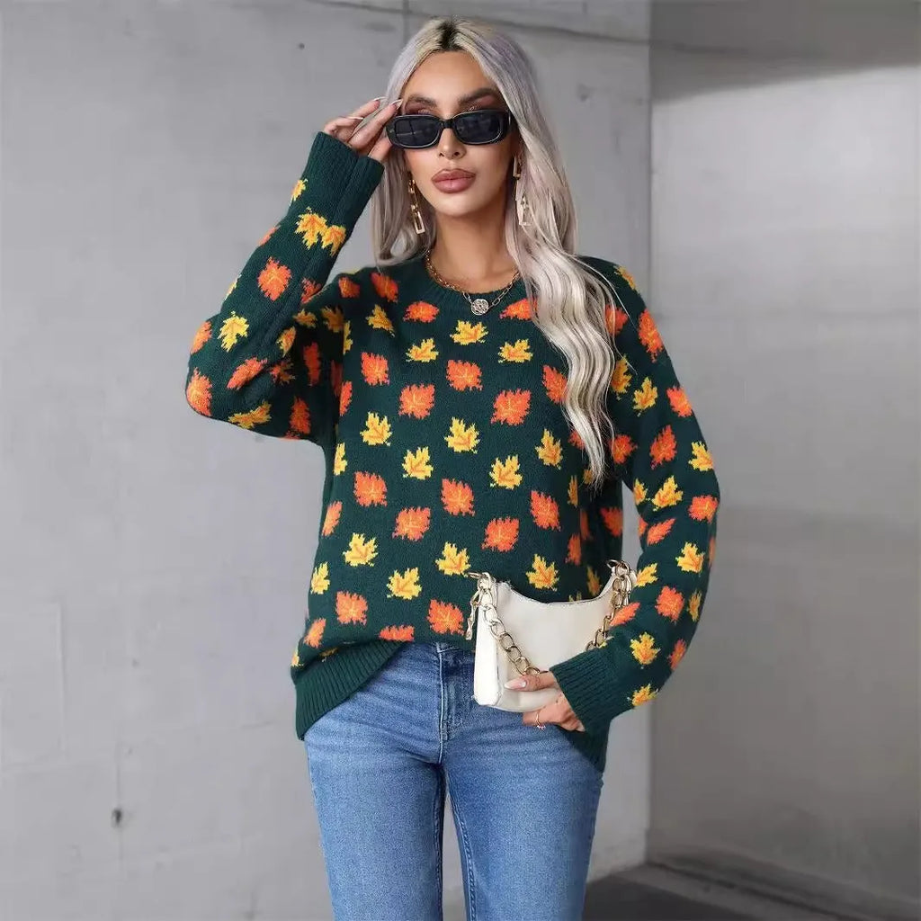 Beige and dark green loose fit Christmas sweater with maple leaf design and round neck.