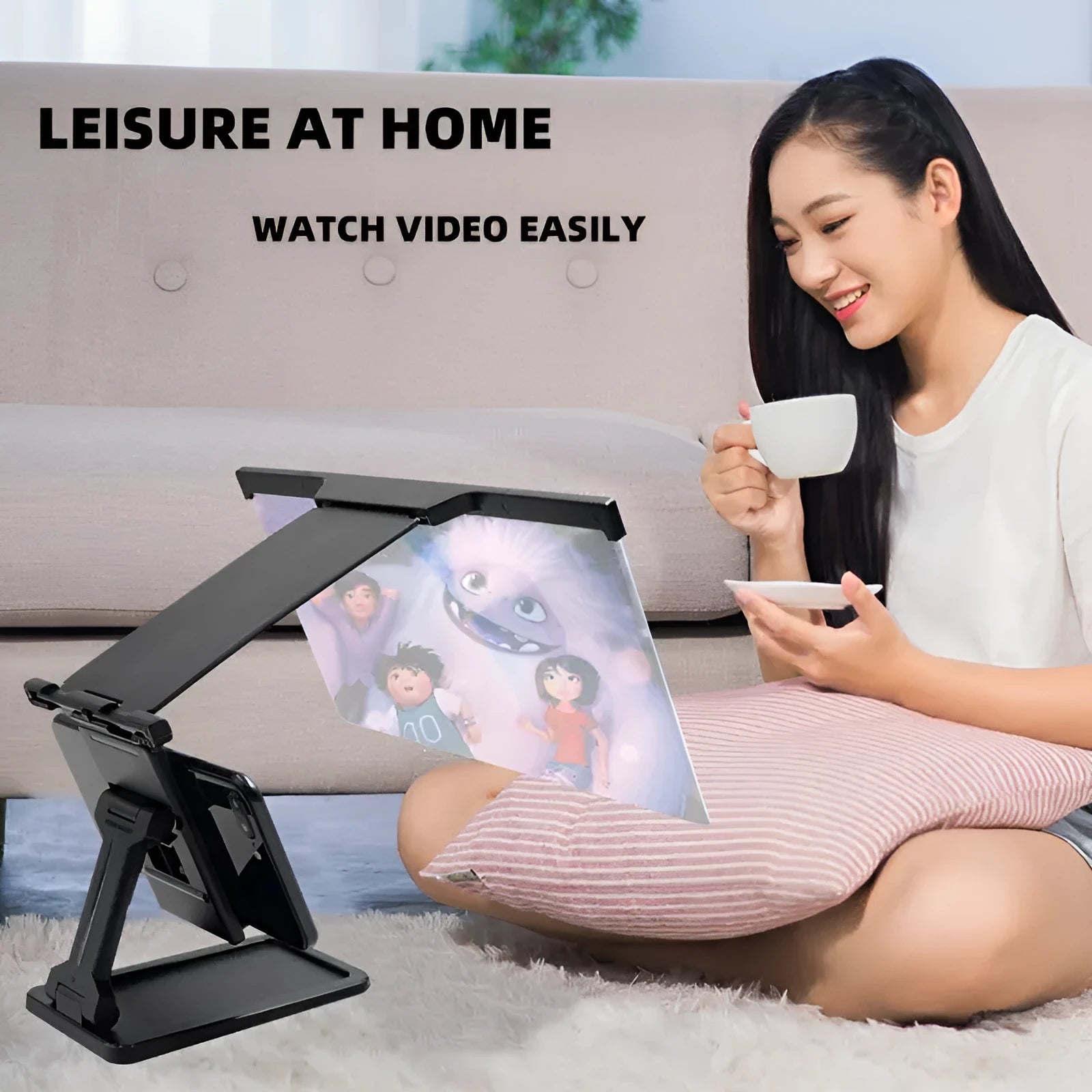 Black folding mobile phone screen magnifier with detachable holder next to an iPhone.