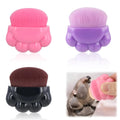 Three paw-shaped pet balm brushes with soft fibre heads in plastic storage boxes