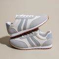 Blue and grey striped casual sports trainers with round toe and flat rubber sole.