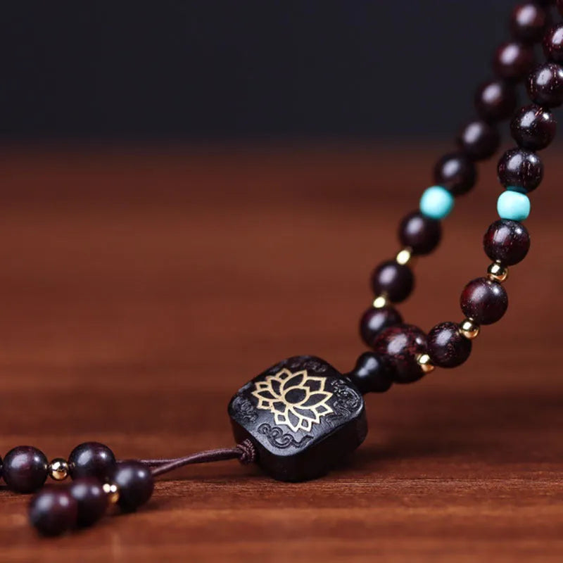 Zambia Rosewood 108-bead bracelet with flat lotus pendant on neutral background