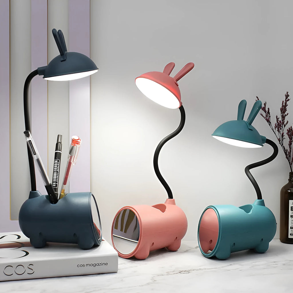 Cartoon-style USB table lamp with integrated pen container in green colour on wooden desk