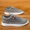 Grey men's high-top canvas bandage sneakers with round toe and PVC sole on a white background