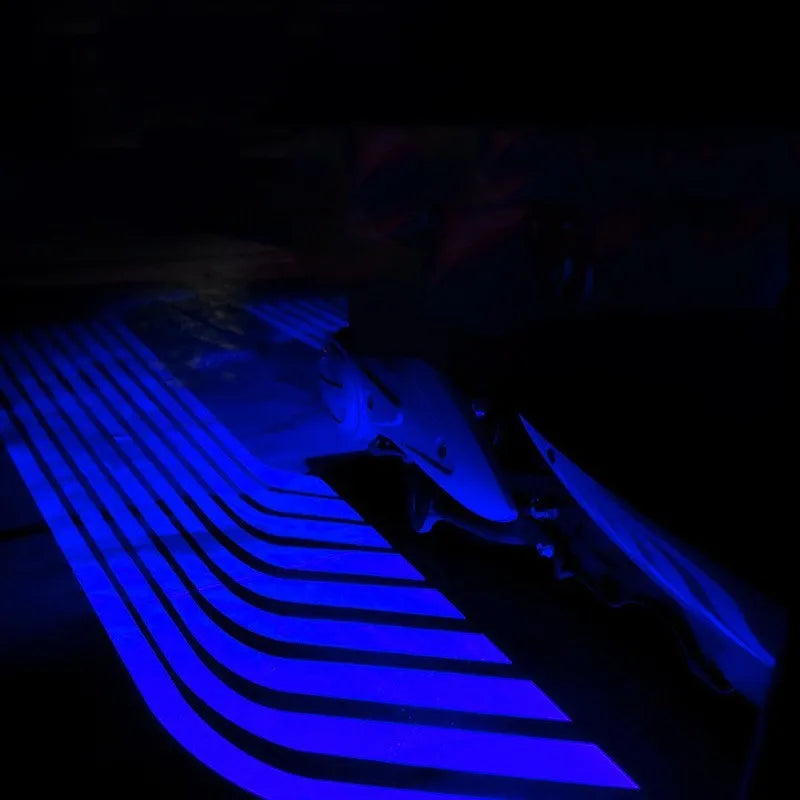 Motorcycle chassis ambience light in aviation aluminium alloy housing with blue LED glow, mounted on bike underside