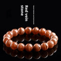 Natural Old Mine Rhodochrosite round bead bracelet on wrist, showing manganese spar colour.
