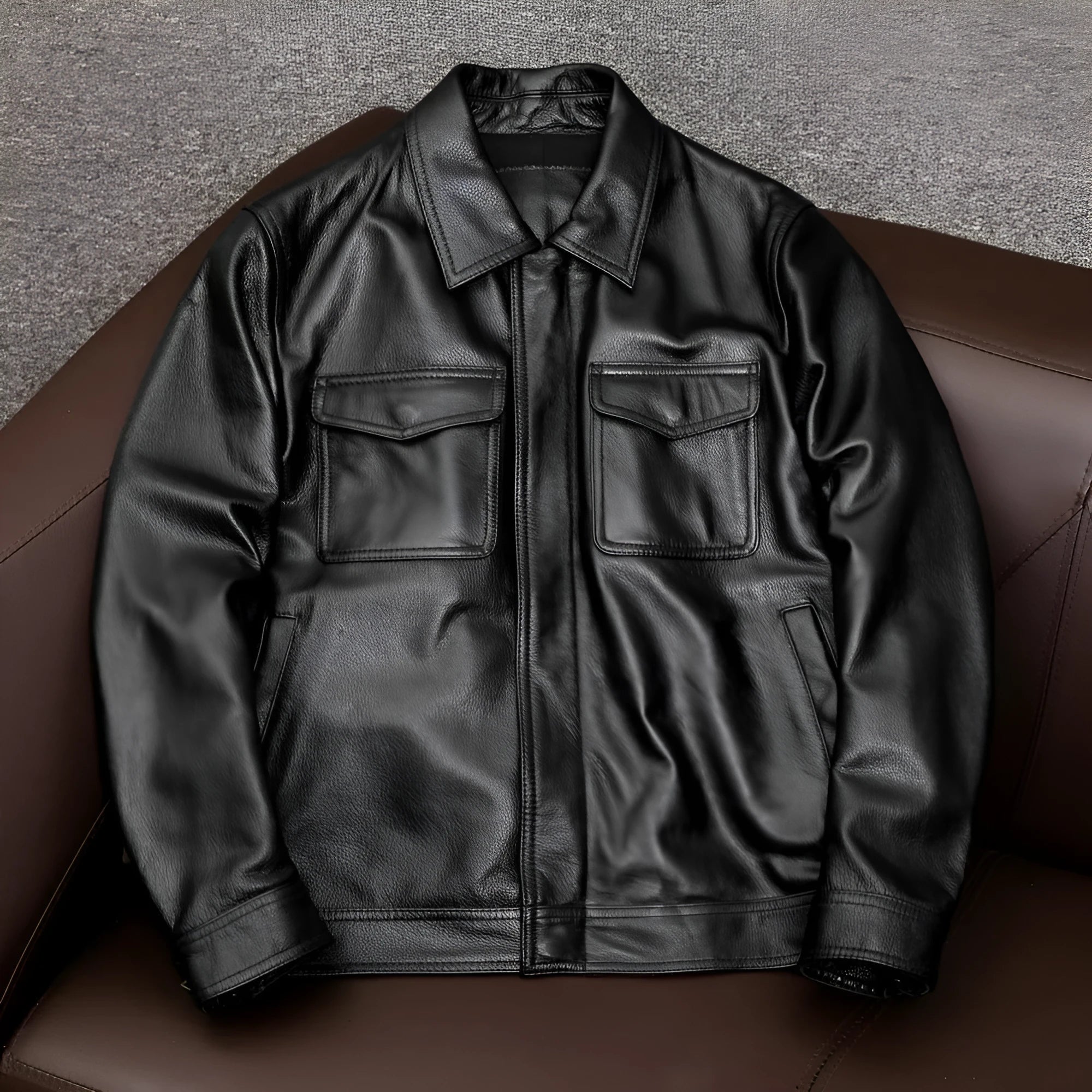 Men's plus size black retro lapel leather jacket with loose fit on hanger.