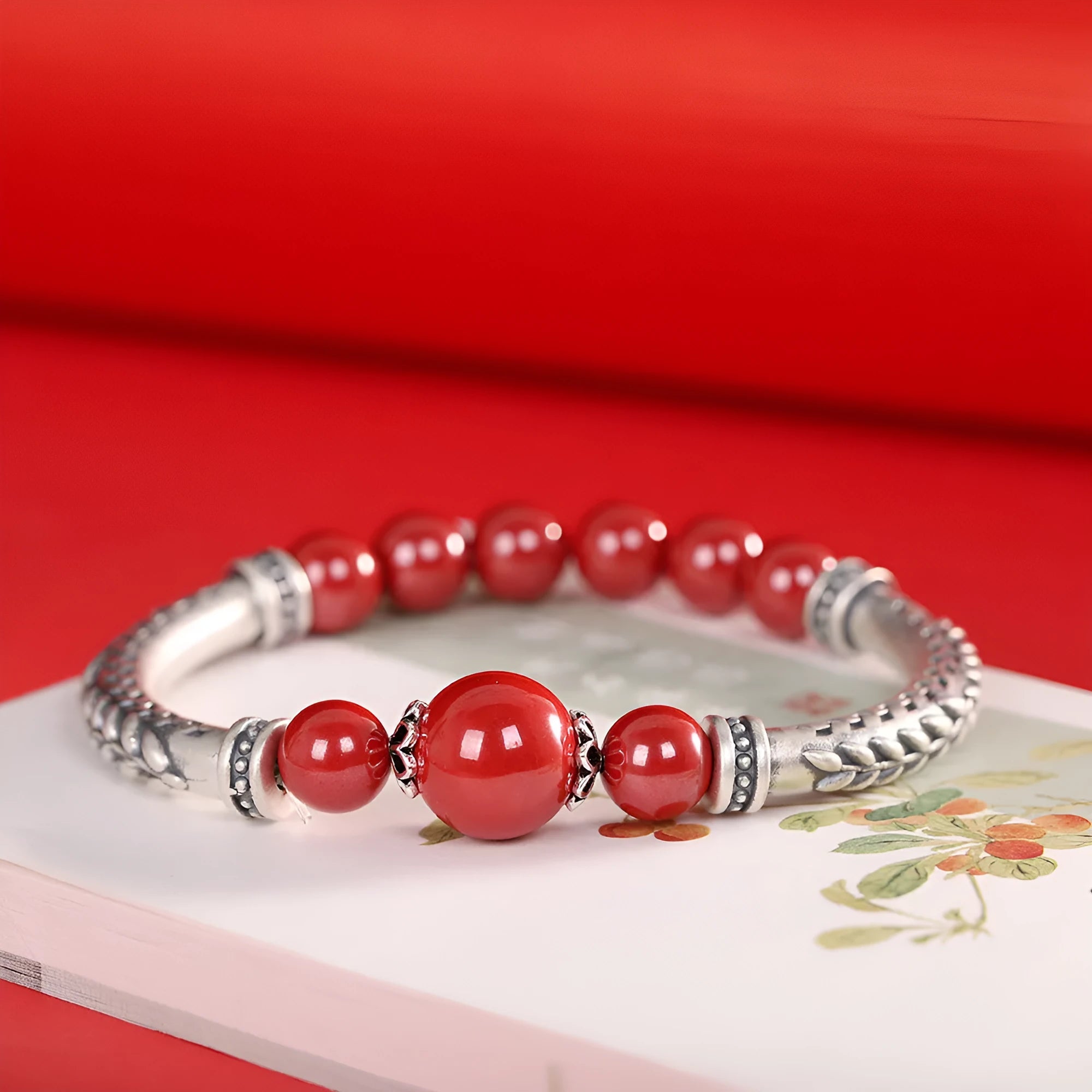 Pure silver 999 cinnabar bracelet with 10mm round retro geometric beads on neutral background