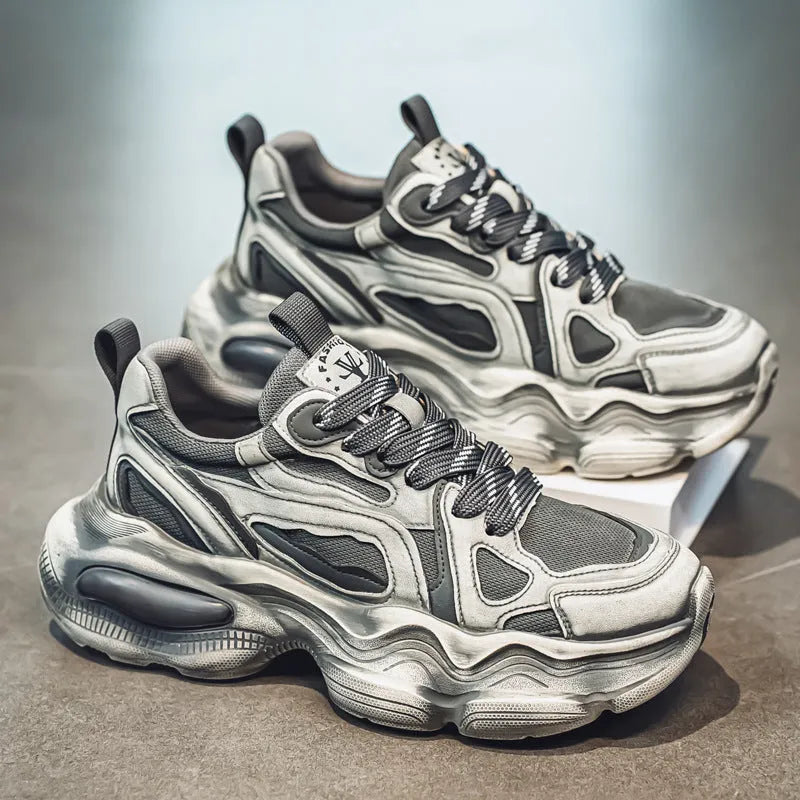 Men's black and white mesh sneakers with a platform sole and lace-up front on a plain background.