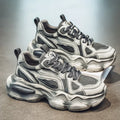 Men's black and white mesh sneakers with a platform sole and lace-up front on a plain background.
