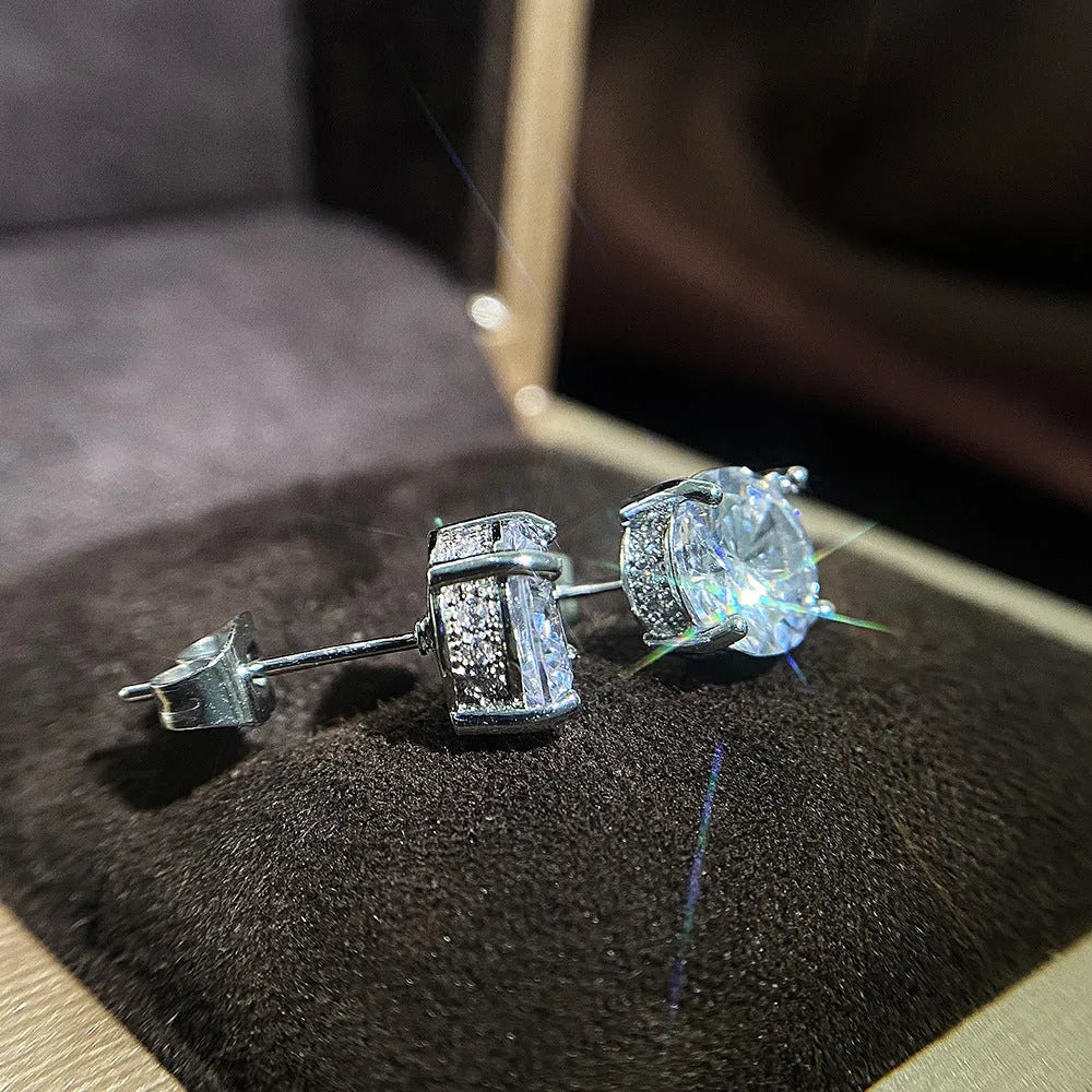 Women's round white zircon stud earrings with copper geometric round shape on display