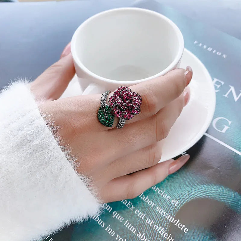 Geometric black gold ring with simulated red corundum stone and gold plating