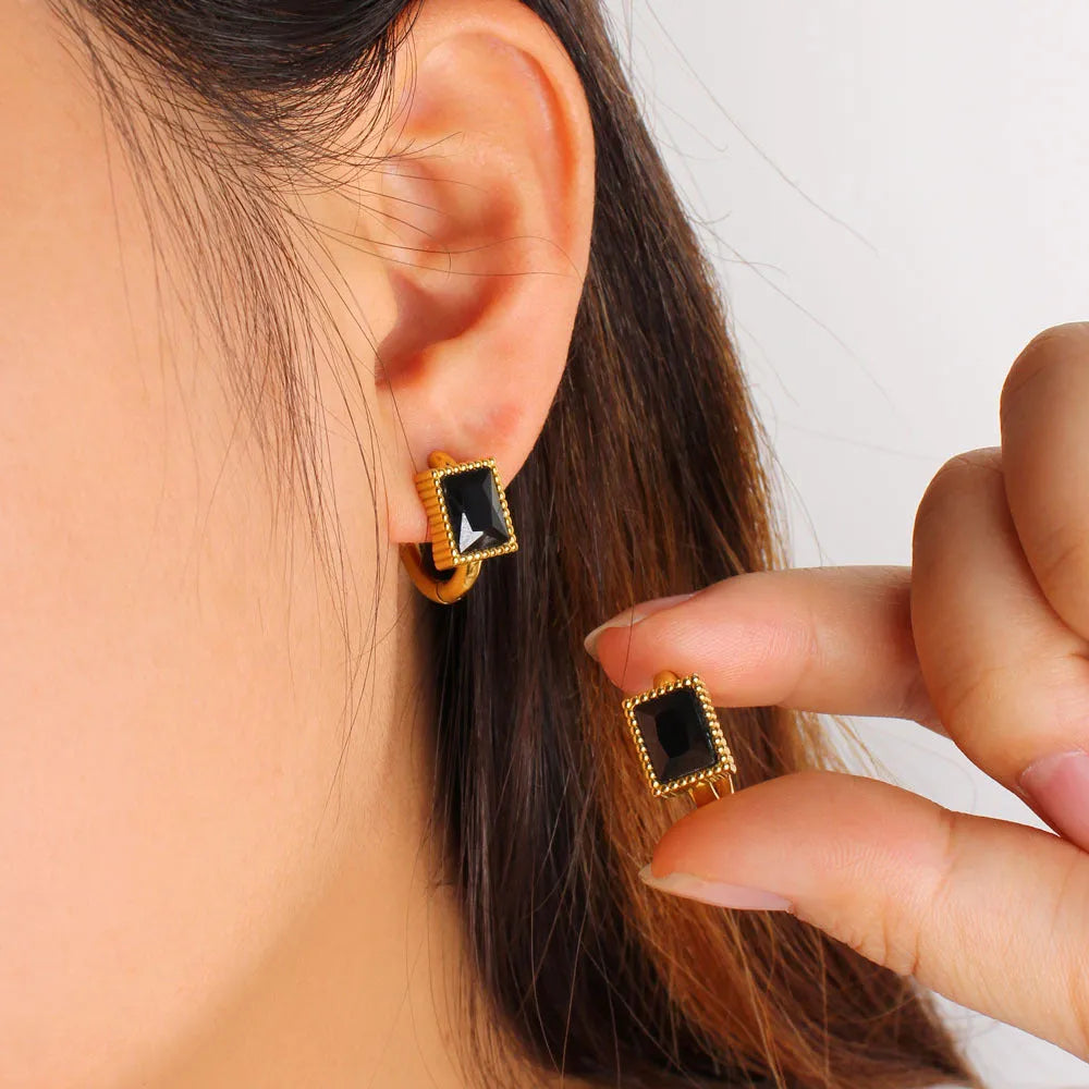 Geometric stainless steel earrings with a square zircon, available in white, black and green.