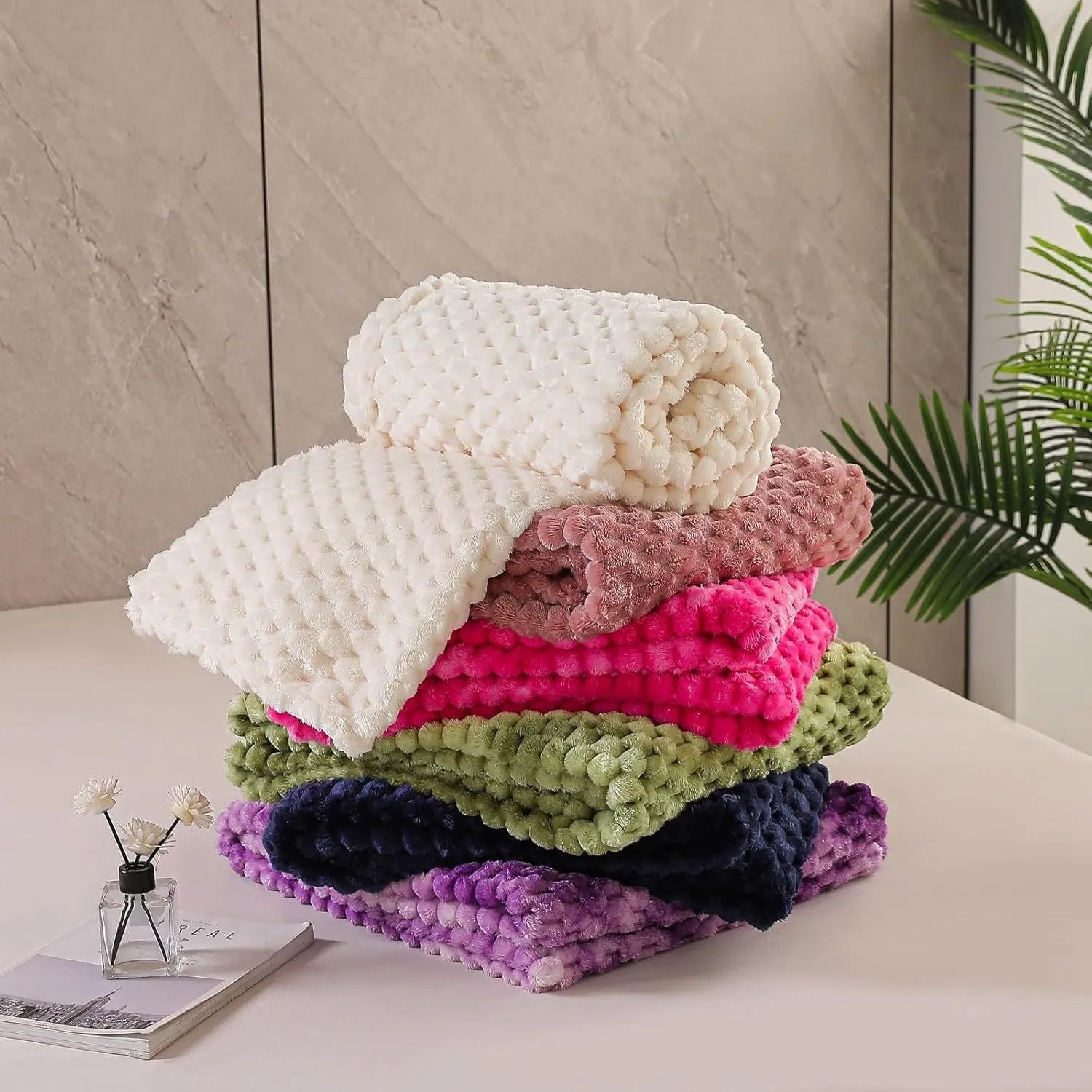 Soft camel-coloured plaid children's blanket folded on a wooden chair.