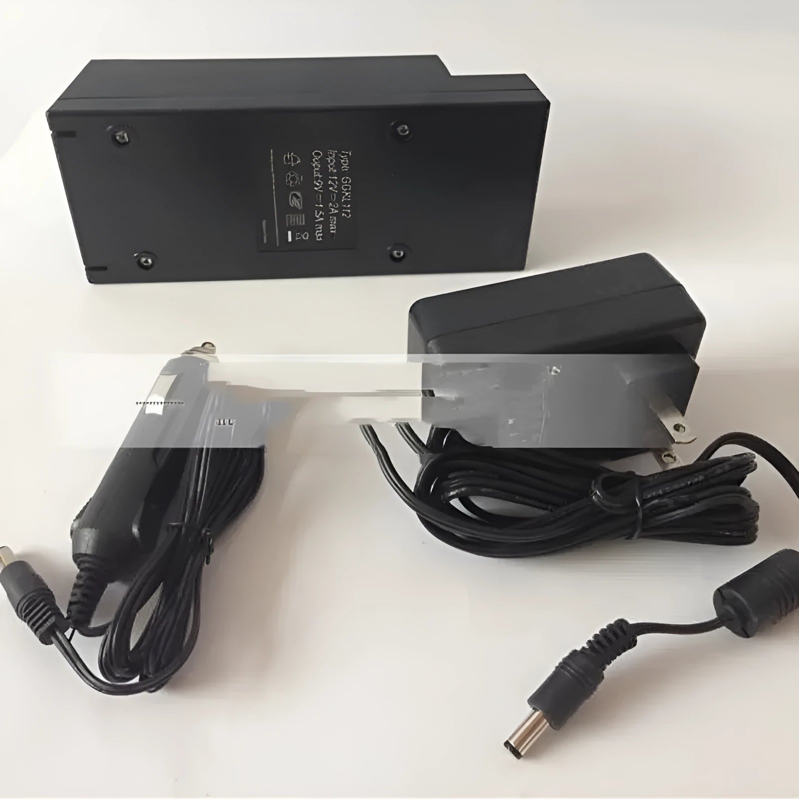 GKL112 compact white 220V car charger unit with UK plug, shown on a car dashboard.