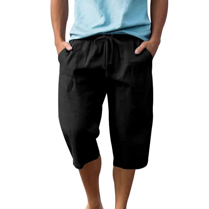 Men's solid colour linen shorts with a drawstring waist shown in a light blue shade.