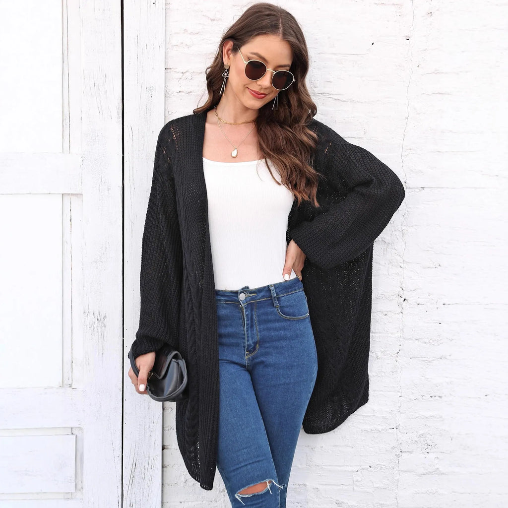 Women's loose fit acrylic sweater coat cardigan in a solid colour on a hanger.