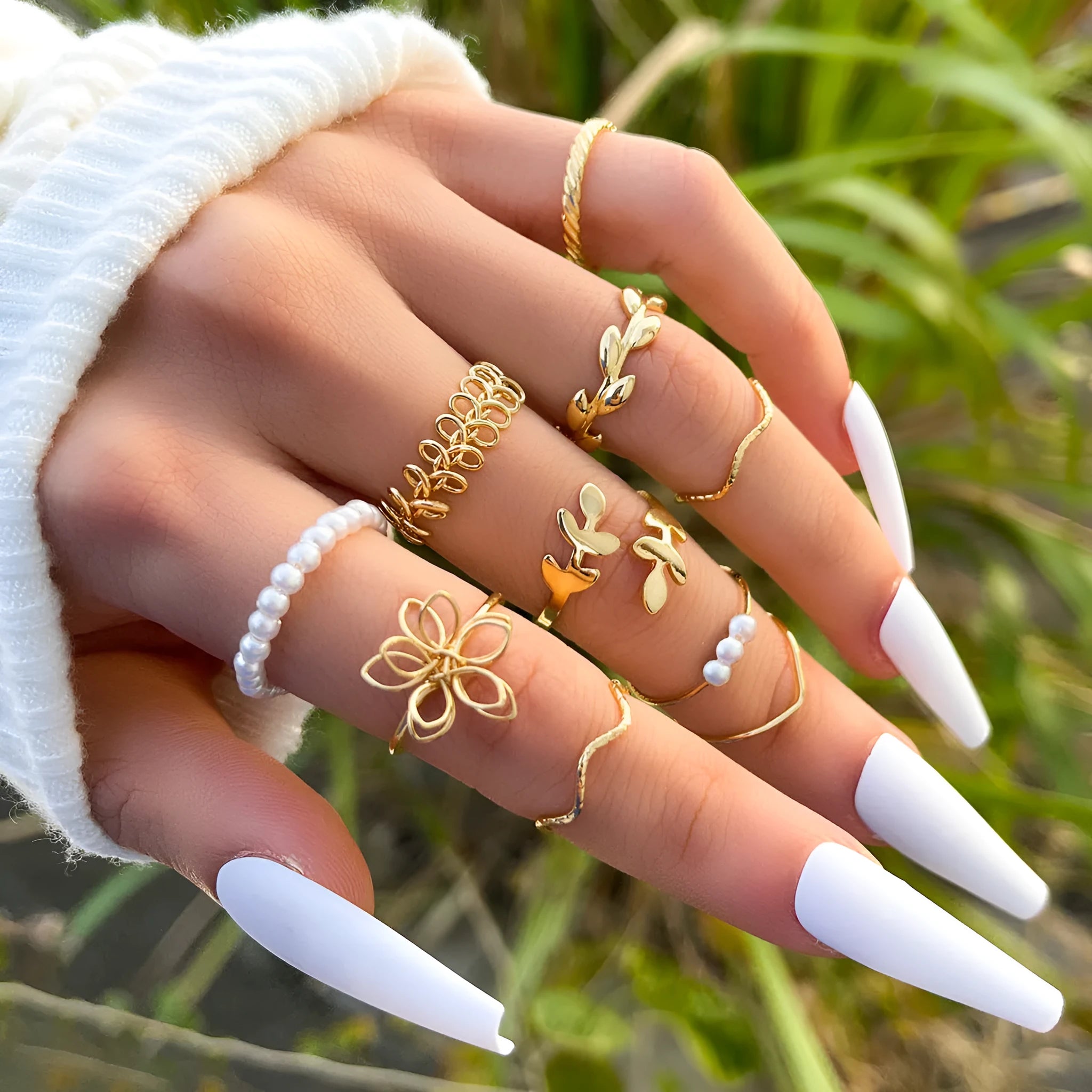 Gold openwork flower alloy ring with glossy electroplated finish on white background