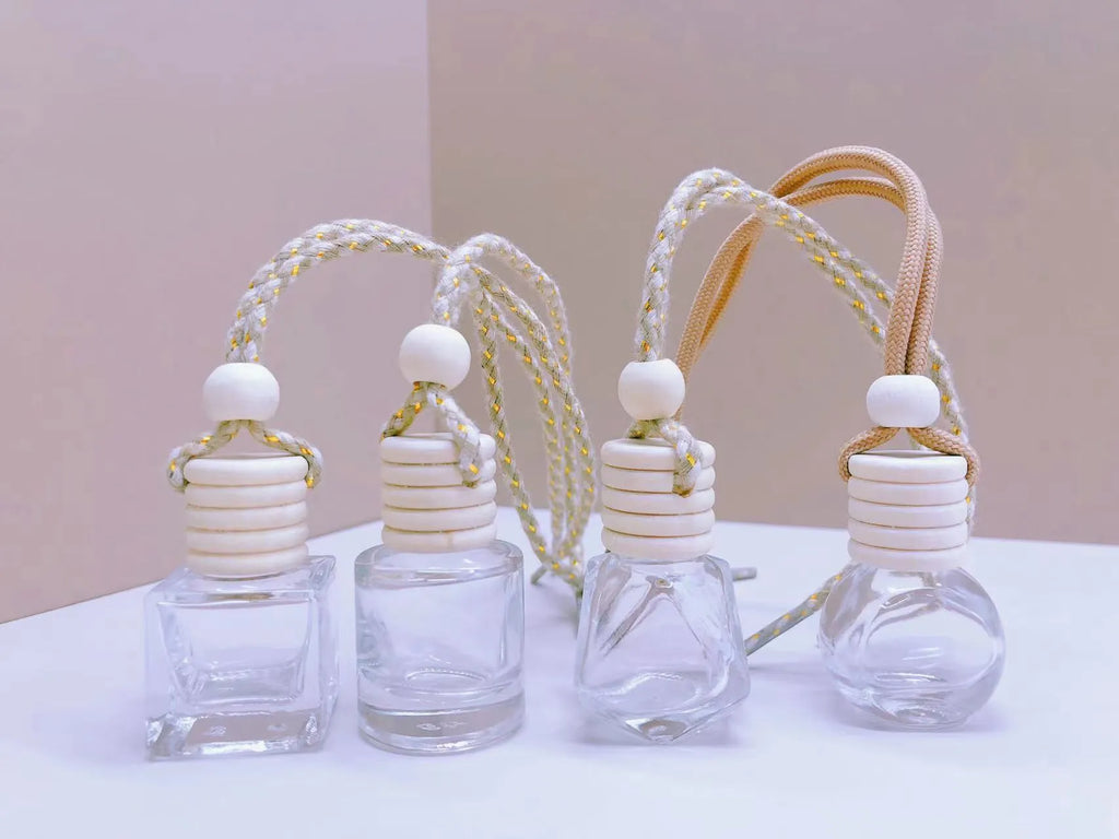 Glass car perfume pendant fragrance diffuser in cylinder, diamond, flat drum, and square styles.