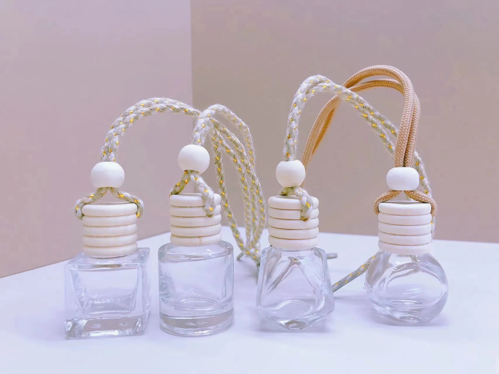 Glass car perfume pendant fragrance diffuser in cylinder, diamond, flat drum, and square styles.
