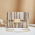 Women's soft straw cross-body bag in small horizontal square shape showing internal mobile phone compartment