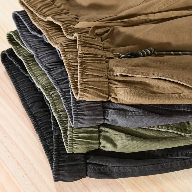 Men's army green cotton overalls with drawstring waist and ankle banded cuffs laid flat