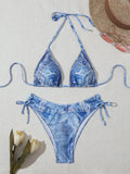Women's denim blue printed bikini set with adjustable straps on a mannequin.