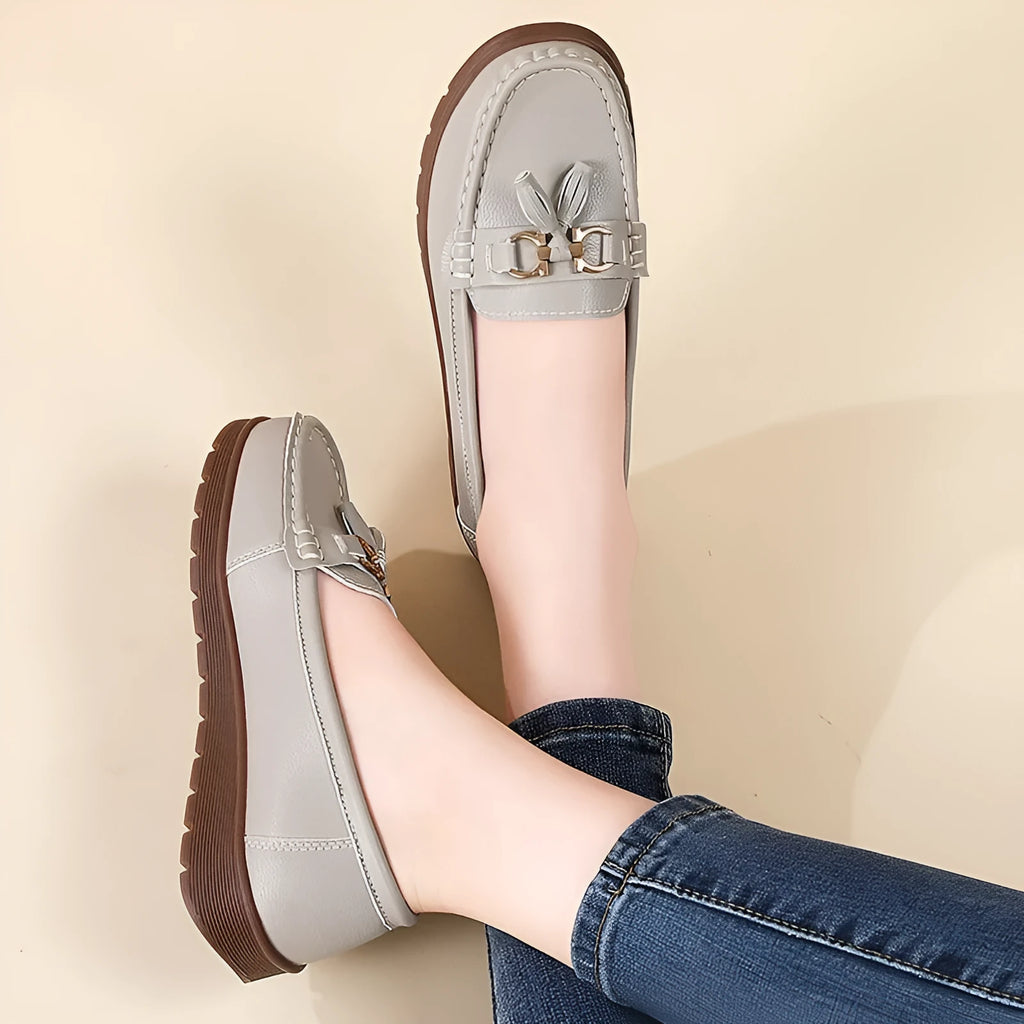 Women's plus size flat moccasins loafers with tassels, round toe, low wedge heel, solid colour suede upper, slip-on style in beige, gray, and pink